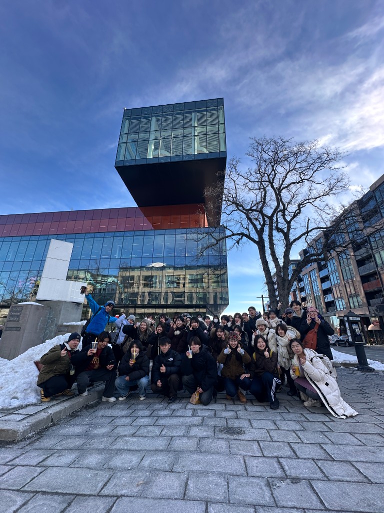 Friends gathered outside the library in winter